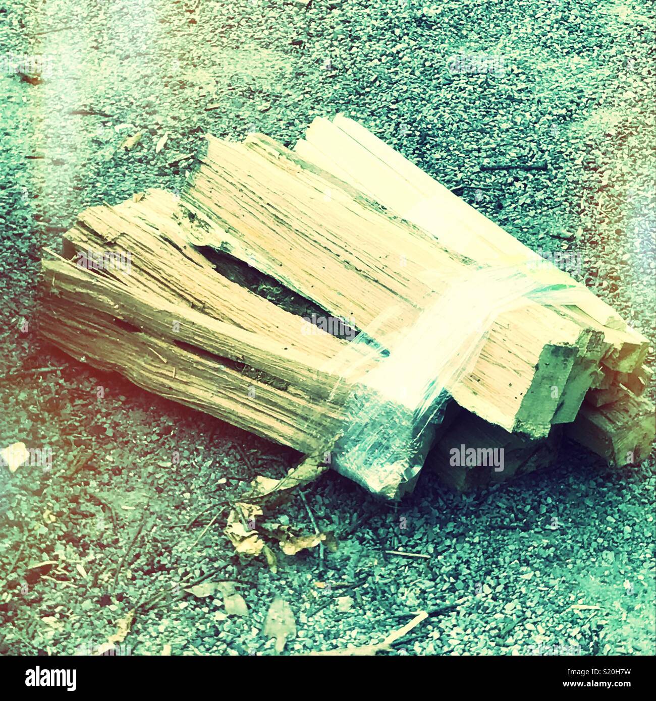 A bundle of wood sits ready to be added to a campfire. - Smartphone Captured Stock Image