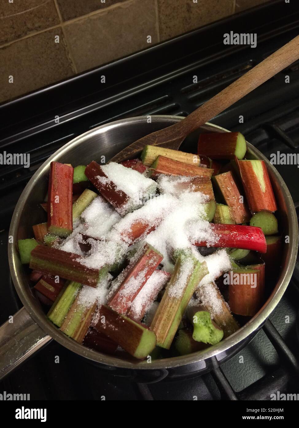 Saucepan full of fresh rhubarb and sugar Stock Photo