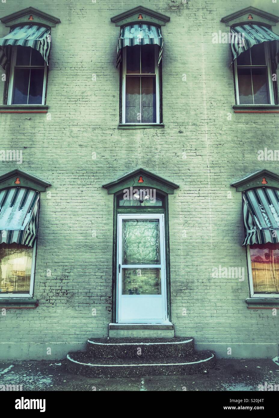 Old brick building with striped awnings - Smartphone Captured Stock Image