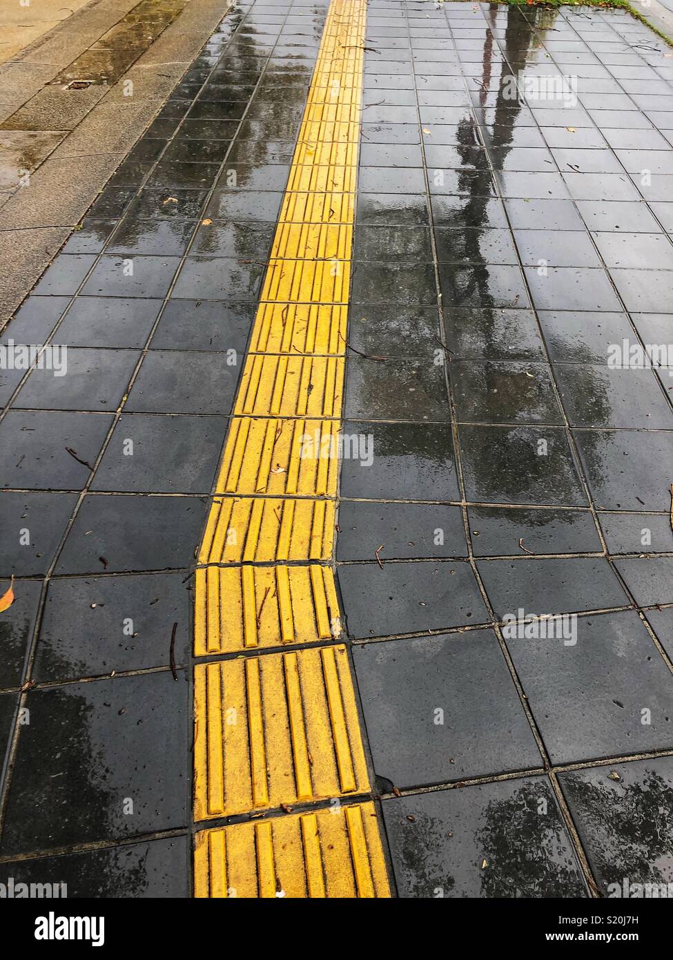 Reflections on a wet sidewalk. Stock Photo