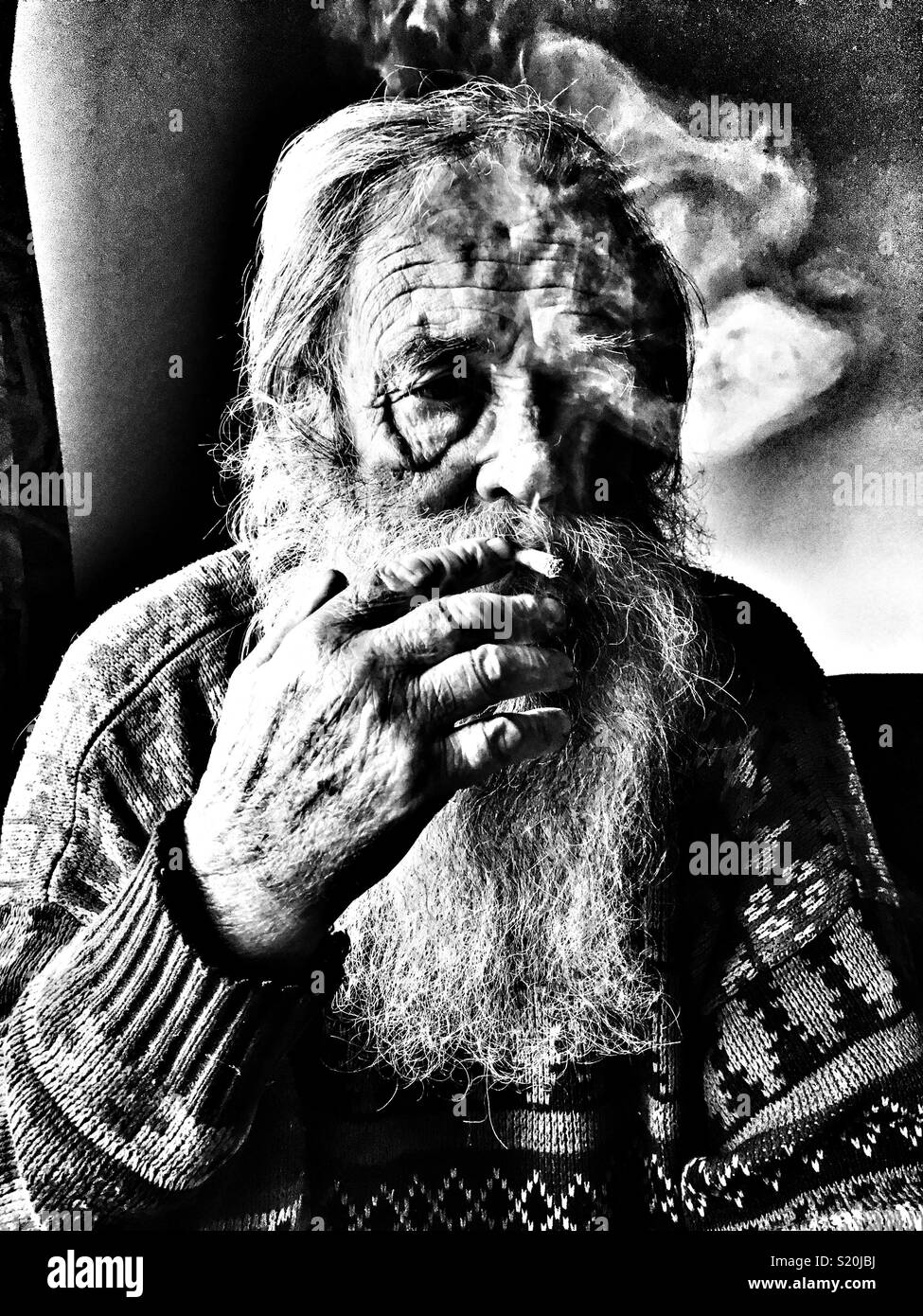 Elderly man smoking a cigarette Stock Photo