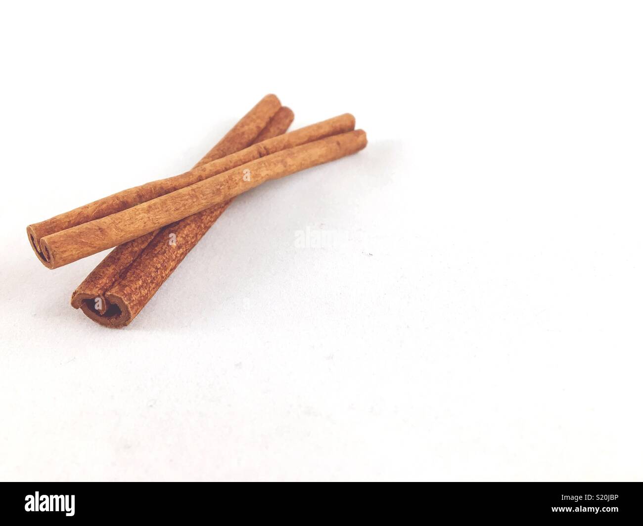 Cinnamon bark on white Stock Photo Alamy