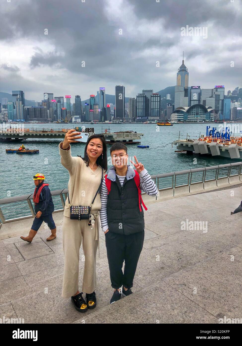 Taking selfies on Hong Kong’s waterfront. - Smartphone Captured Stock Image
