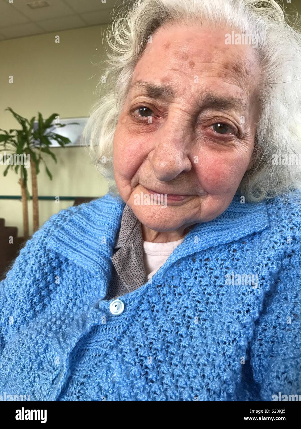 Lovely old lady smiling and looking at the camera. - Smartphone Captured Stock Image