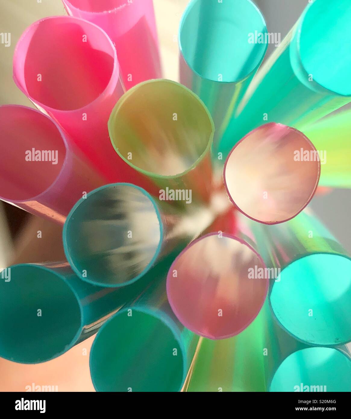 Abstract image of tops of multi-coloured plastic drinking straws with daylight light shining through - Smartphone Captured Stock Image