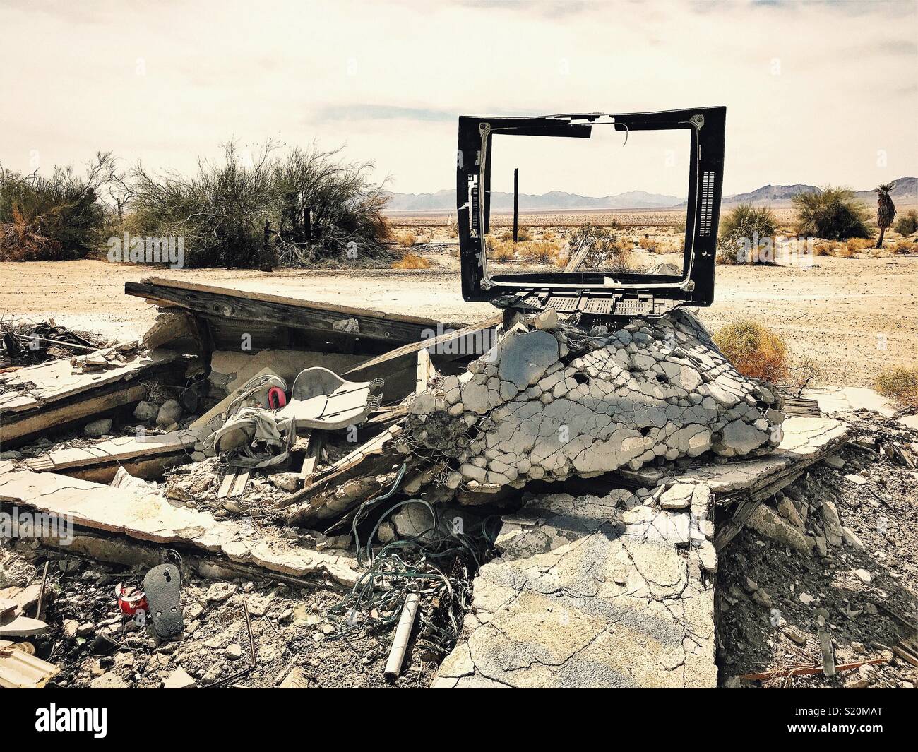 Abandoned and collapsed building with old television frame on debris pile in the middle of the Mohave Desert near Palm Springs, California. - Smartphone Captured Stock Image