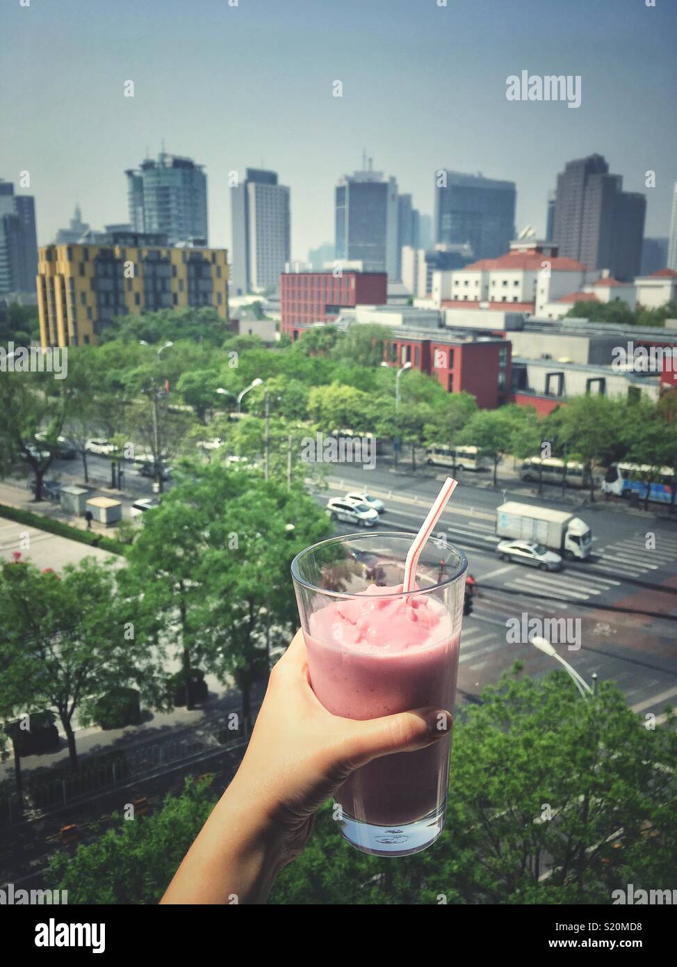 Have a glass of strawberry milkshake with overview skyline of Beijing, China. Stock Photo