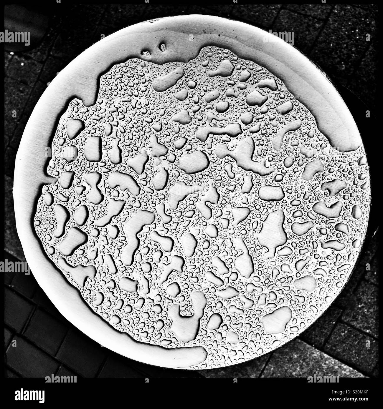 Raindrops on top of a metal street bollard in London - Smartphone Captured Stock Image