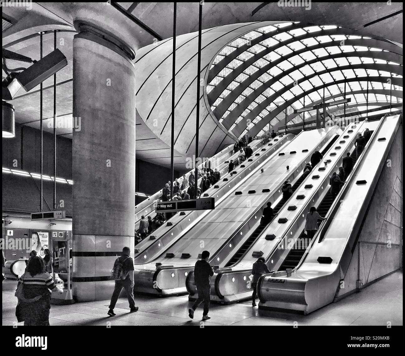 A monochrome image of the famous escalators at Canary Wharf Underground Station in the Docklands area of London, England. This TfL station is one of “the most loved.” Photo Credit - © COLIN HOSKINS, - Smartphone Captured Stock Image