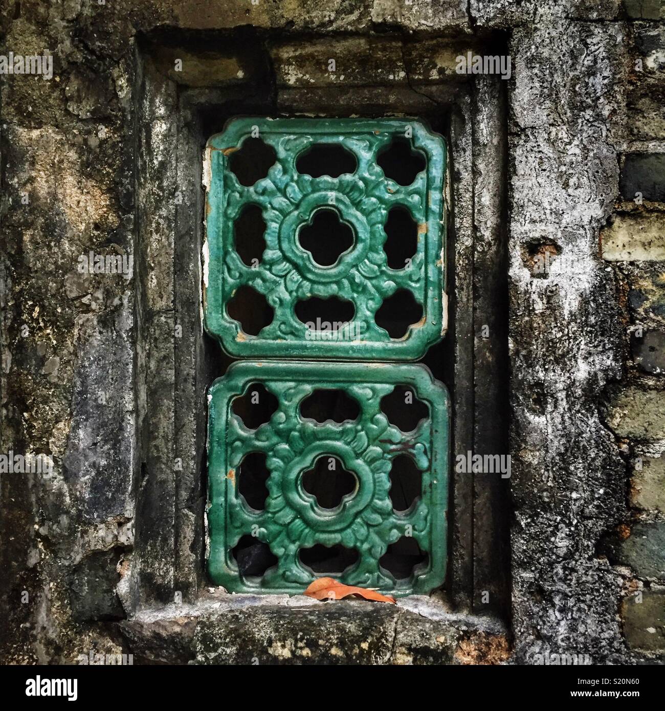 Traditional Chinese tiles in a window of an abandoned house in Luk Keng village, New Territories, Hong Kong Stock Photo
