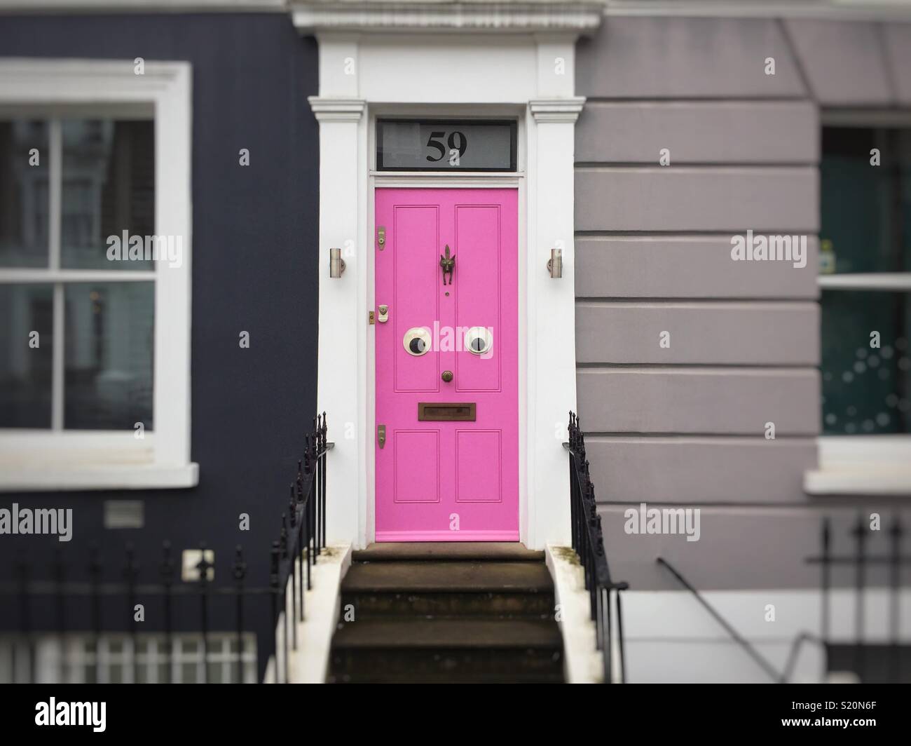 Steps Lead Up To A Pink Front Door With Eyes In Notting Hill