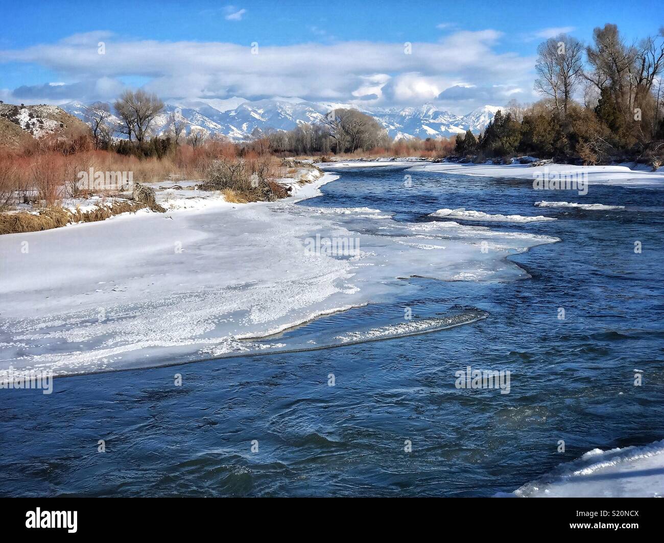 Ice forming on a winter afternoon at 14°F on the Gallatin River near Three Forks, Montana, USA - Smartphone Captured Stock Image