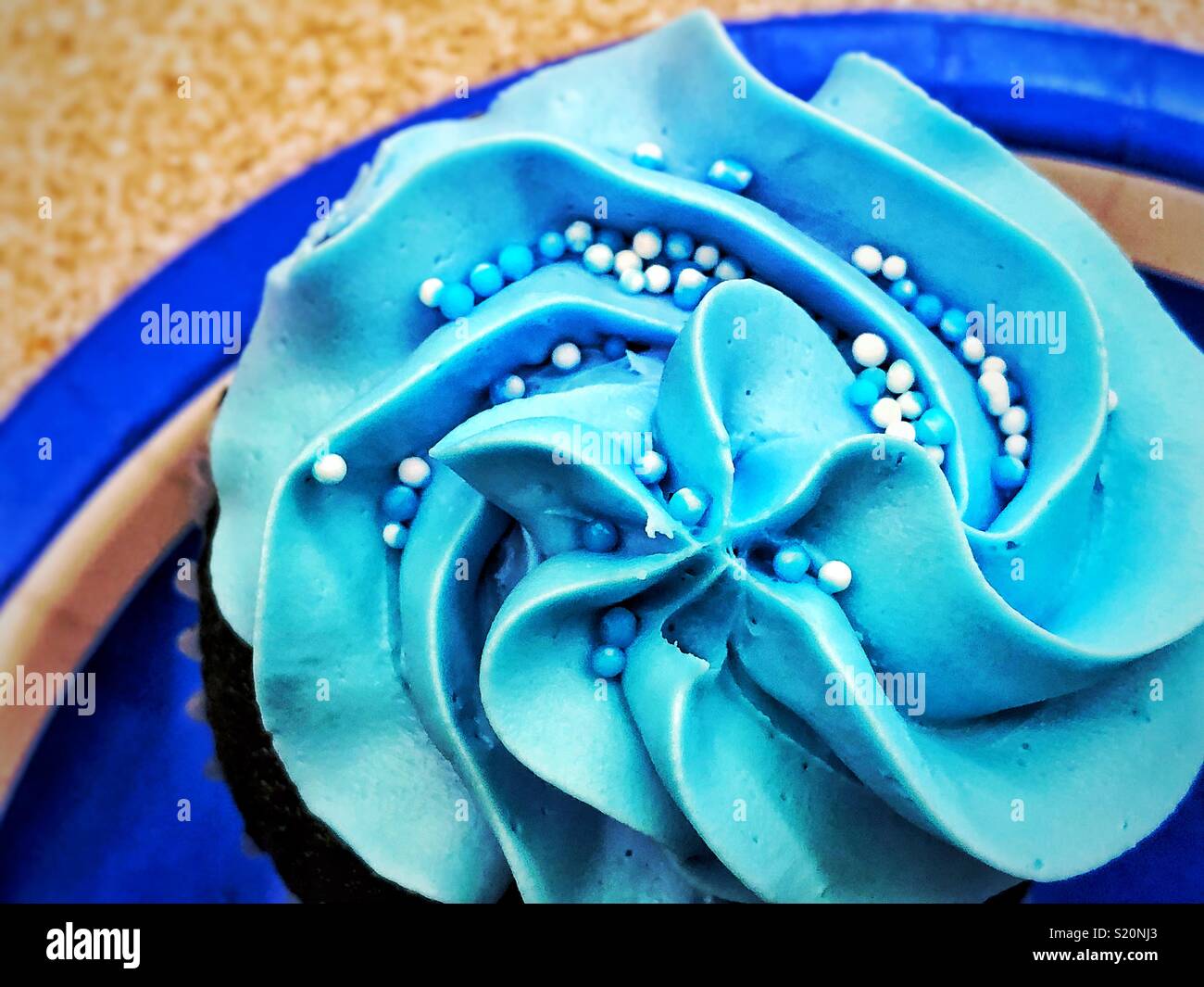 Bright blue frosting on cupcake at boy baby shower Stock Photo