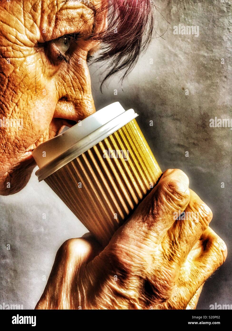 Elderly woman drinking from a take away disposable coffee cup - Smartphone Captured Stock Image