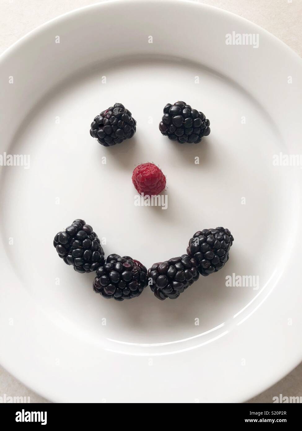 Blackberry and Raspberry Smiley face - Smartphone Captured Stock Image