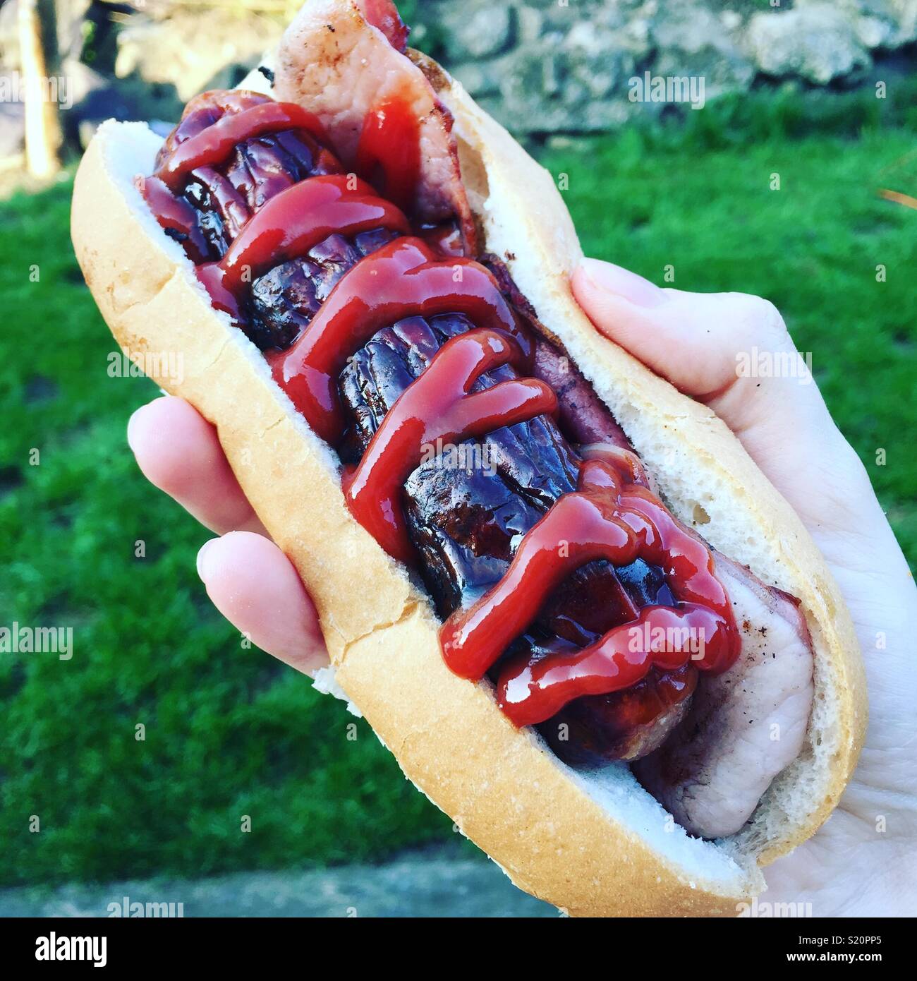 BBQ sausage, bacon and ketchup Stock Photo Alamy