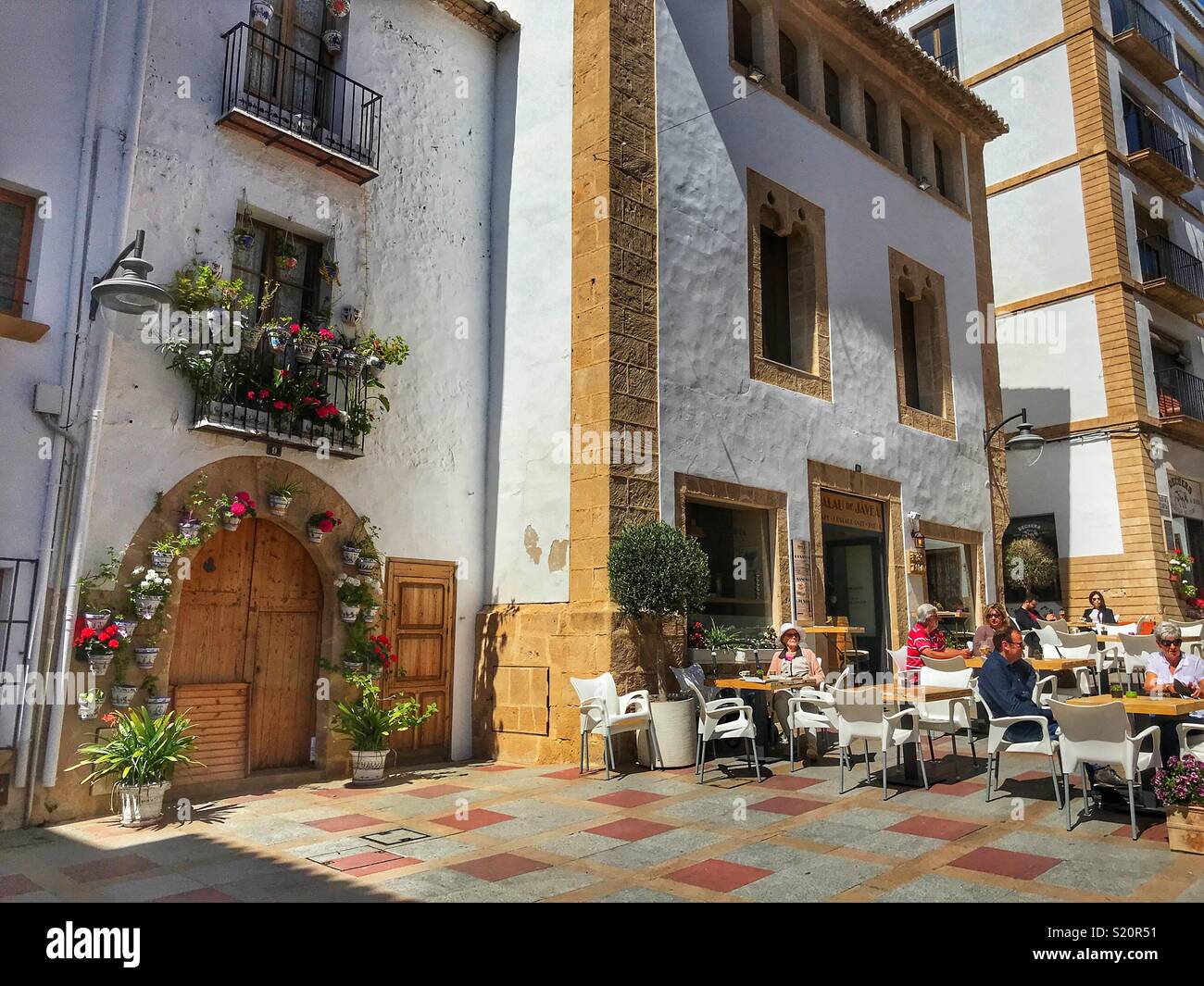 Street scene with people at outdoor cafe, in the Old Town area of Javea / Xabia on the Costa Blanca, Spain - Smartphone Captured Stock Image