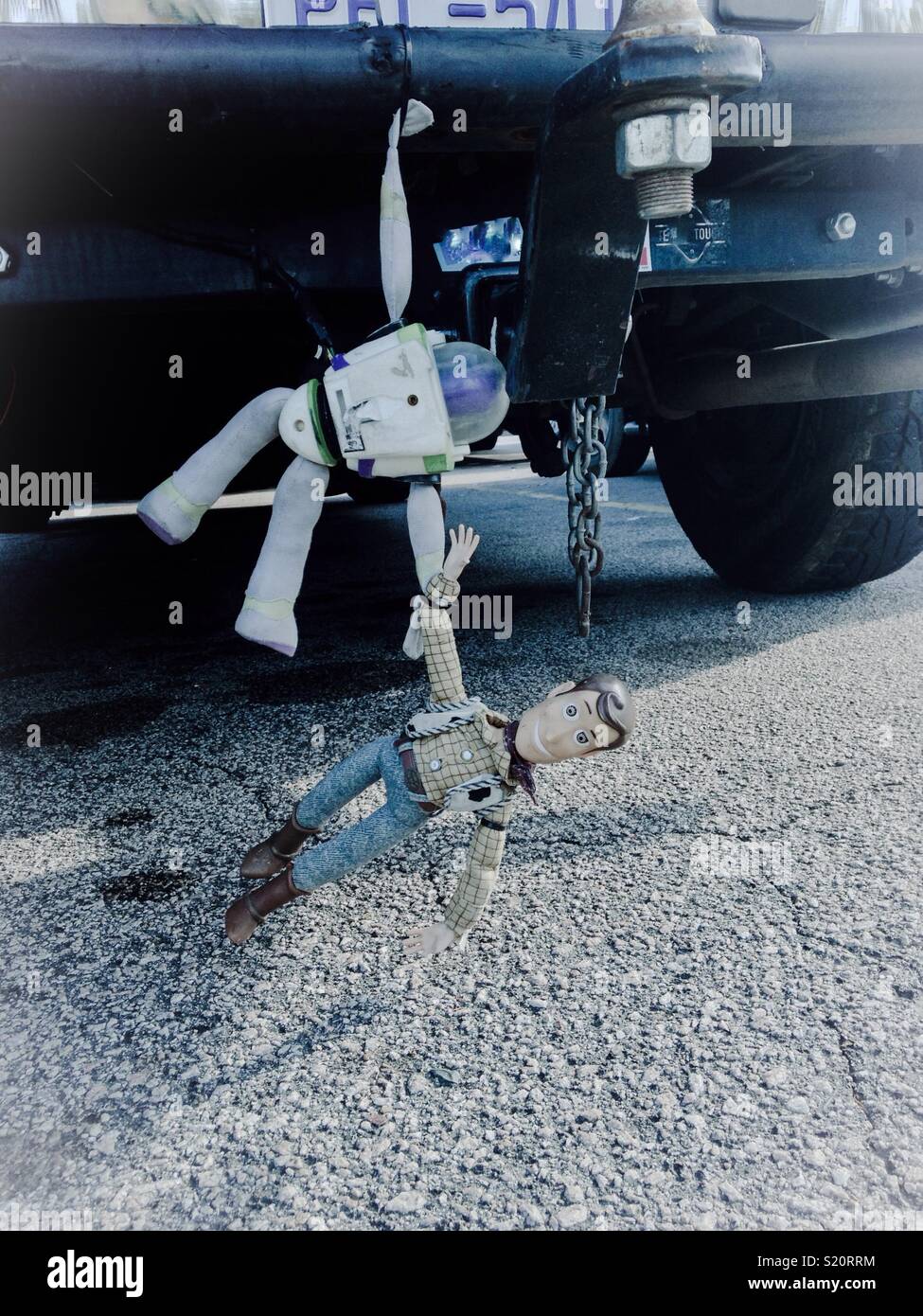 Buzz Lightyear and Woody toys 'clinging' to car bumper- seen in parking lot in North Carolina Stock Photo