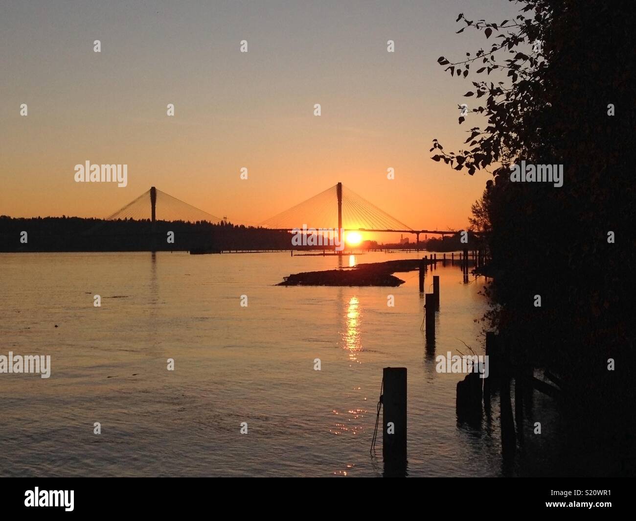 Sunset on the Fraser River by the Port Mann Bridge in Port Coquitlam British Columbia. - Smartphone Captured Stock Image