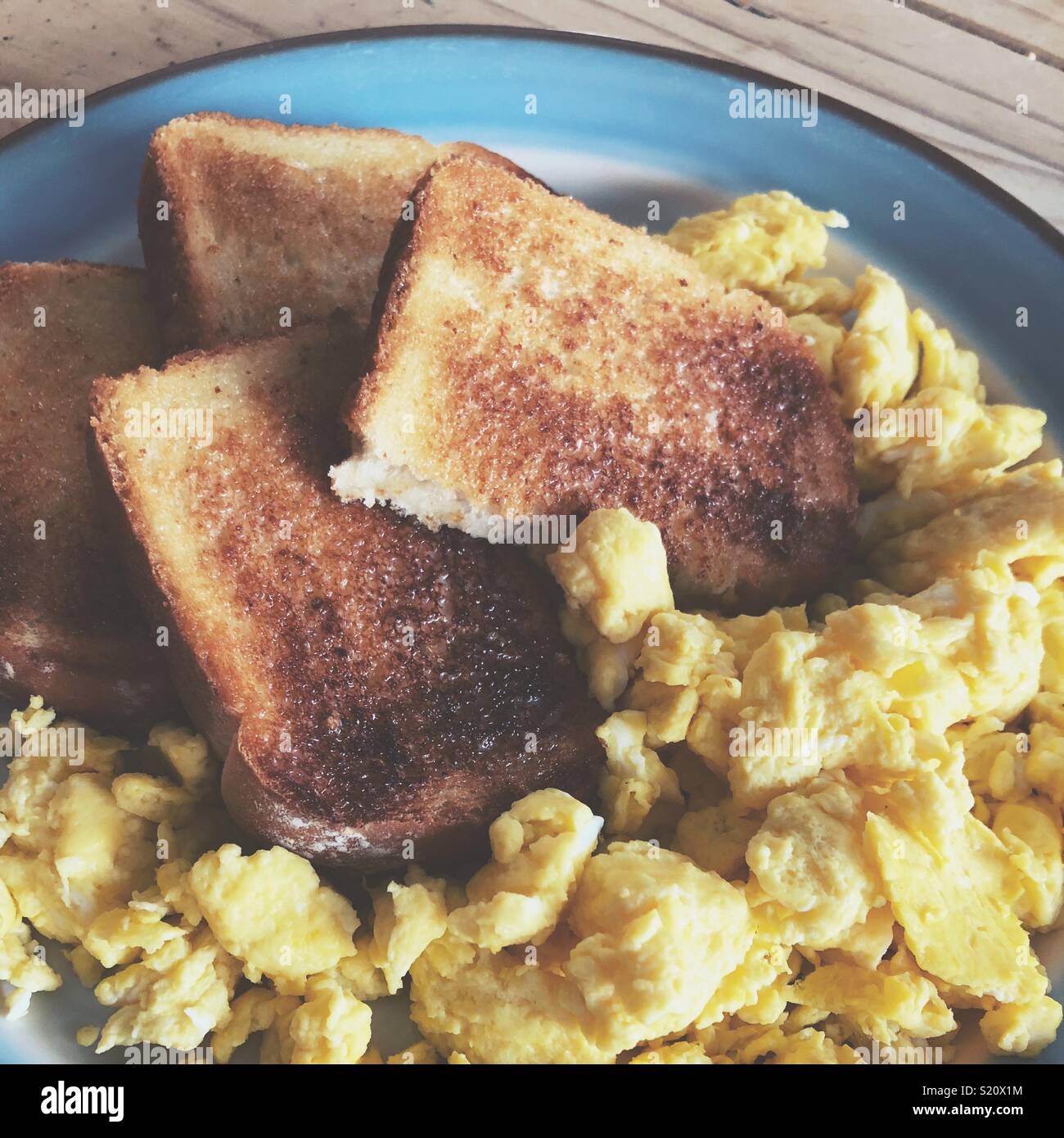 Closeup of scrambled eggs and toast on a plate - Smartphone Captured Stock Image