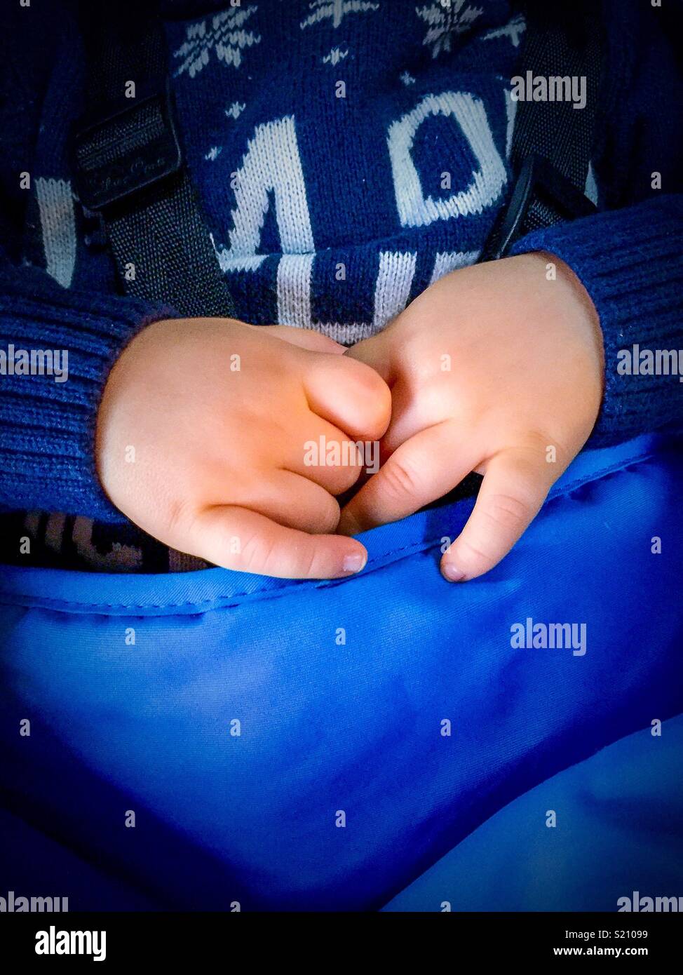 Baby hands, baby clutches hands in stroller Stock Photo