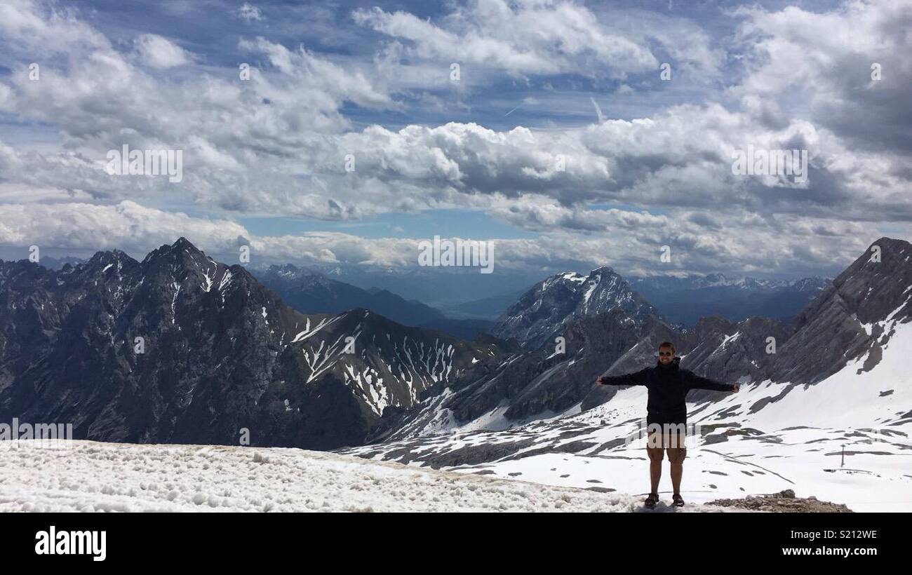 Man at tip of Zugspitze Stock Photo