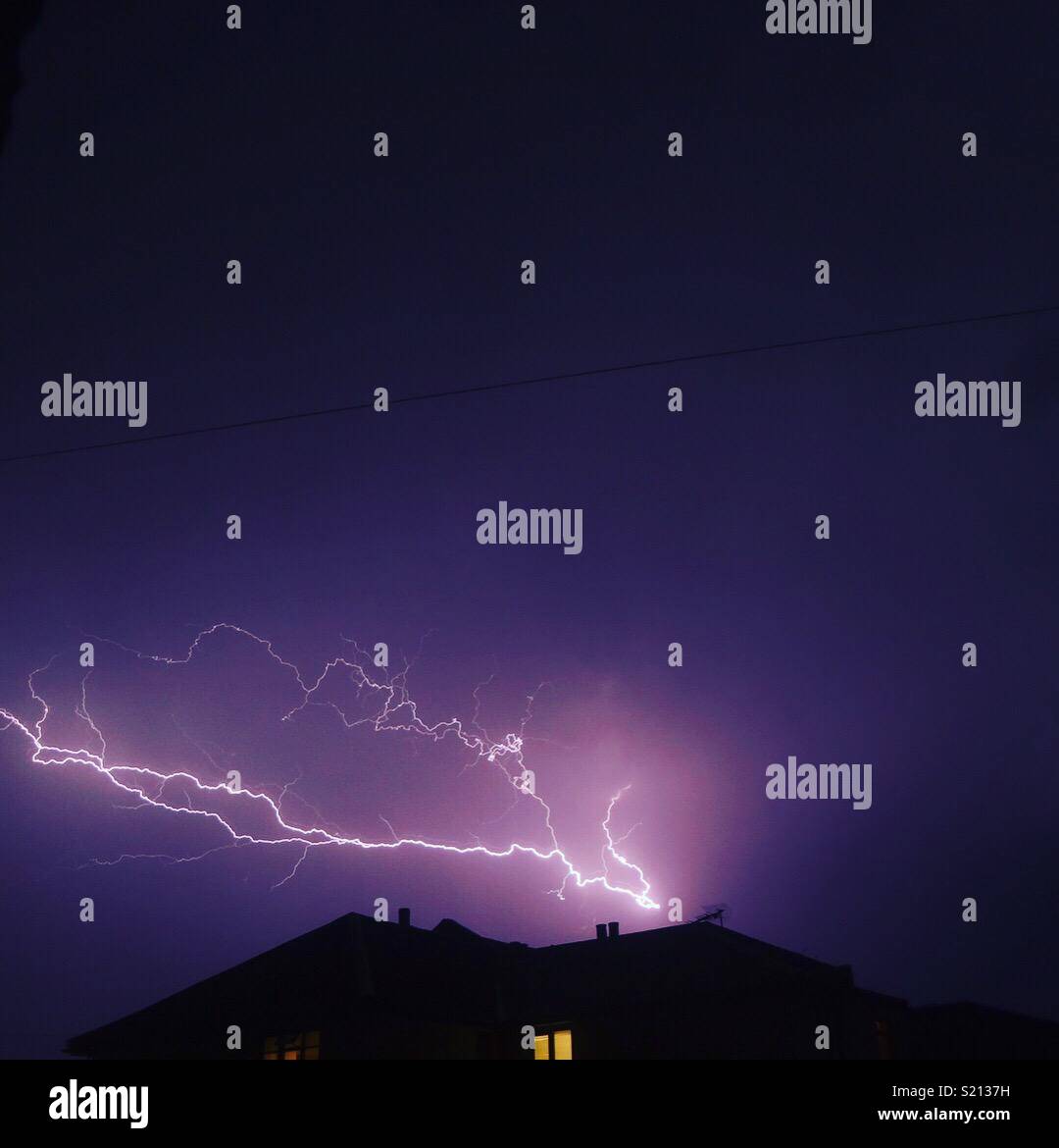 Lightning in the sky over a house Stock Photo Alamy