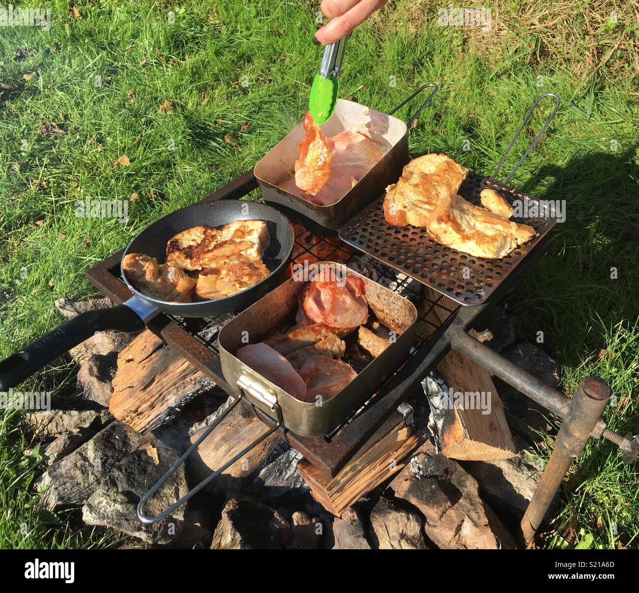 Cooking breakfast on a campsite Stock Photo