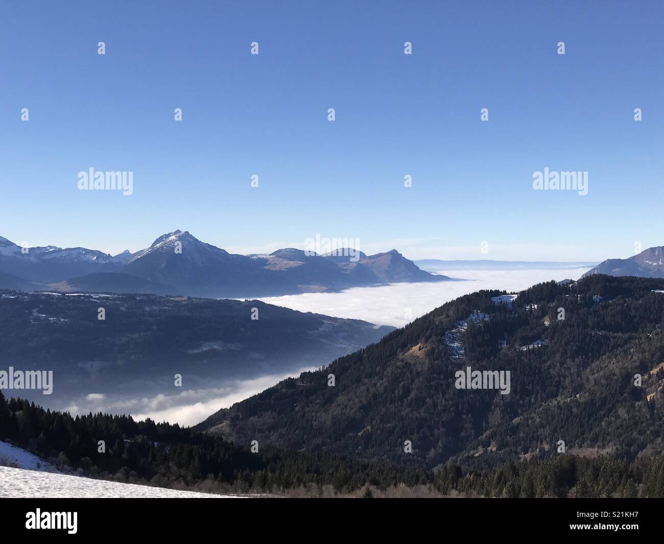 Low cloud hanging below the tops of the French Alps Mountains Stock Photo