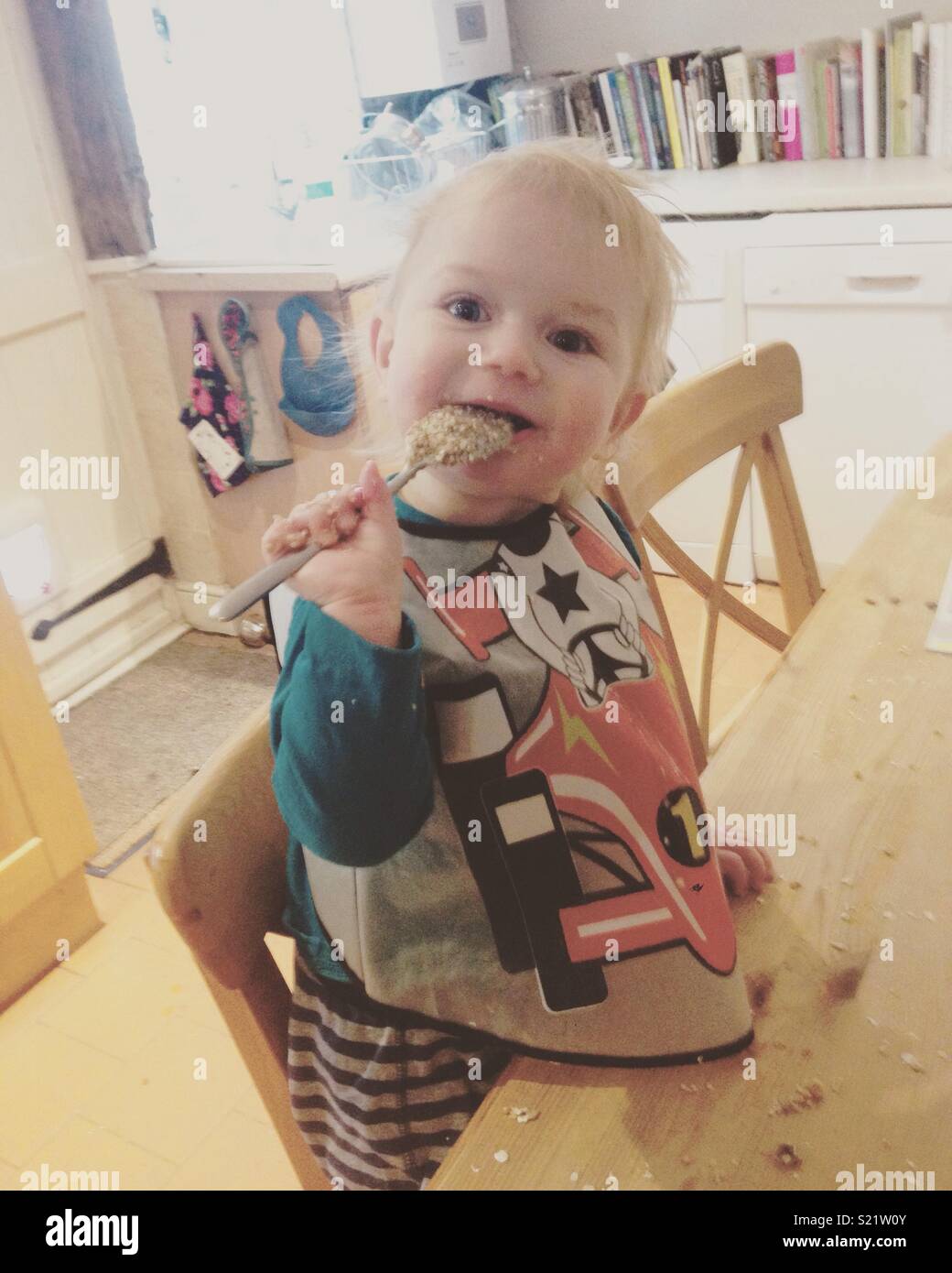 Baby eating porridge Stock Photo
