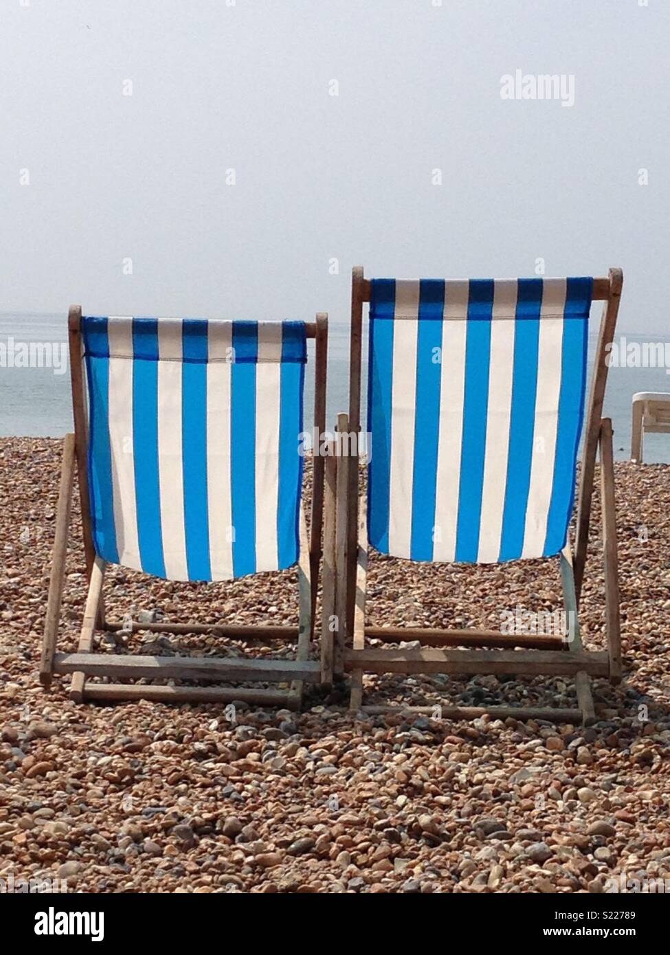 Striped deckchairs on Brighton beach Stock Photo Alamy