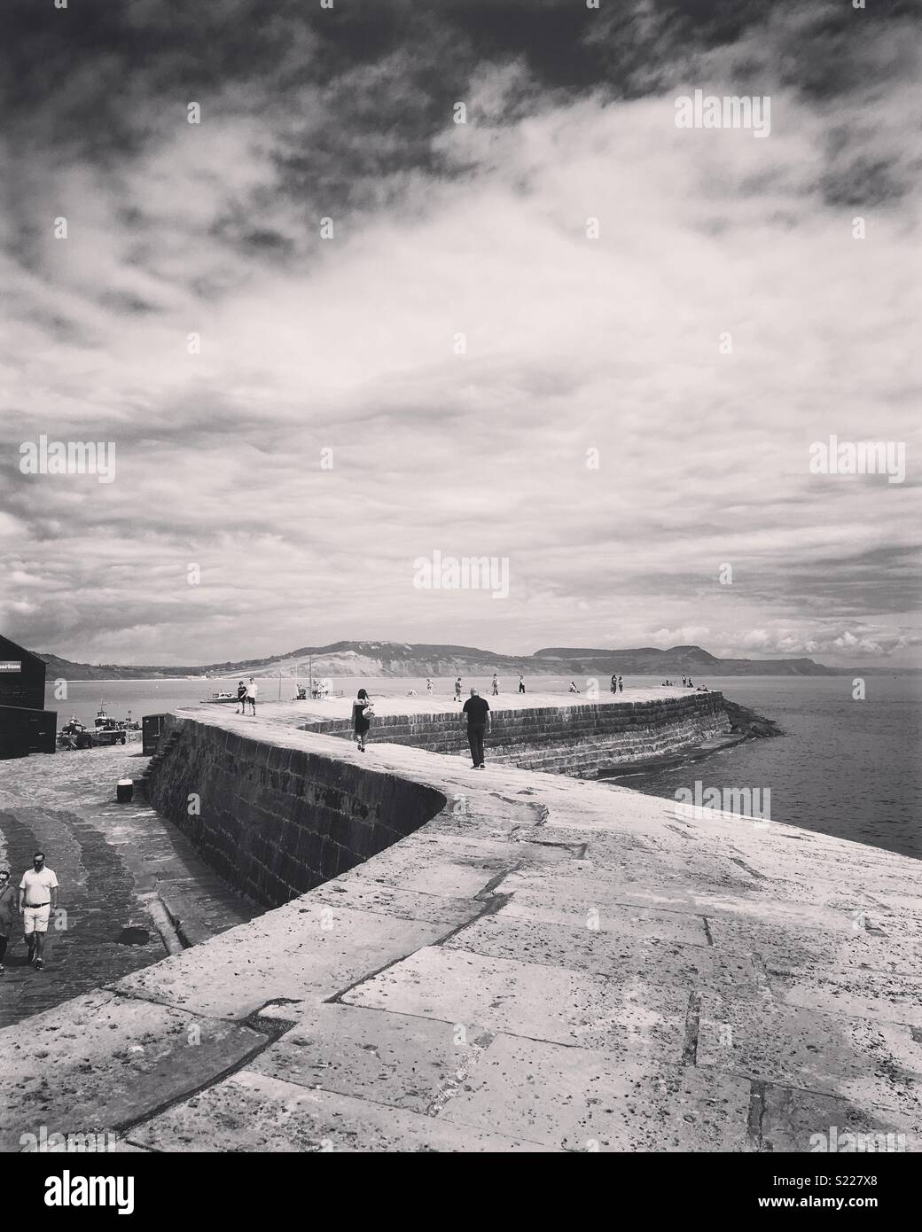 People walking on the Cobb, Lyme Regis, Dorset - Smartphone Captured Stock Image