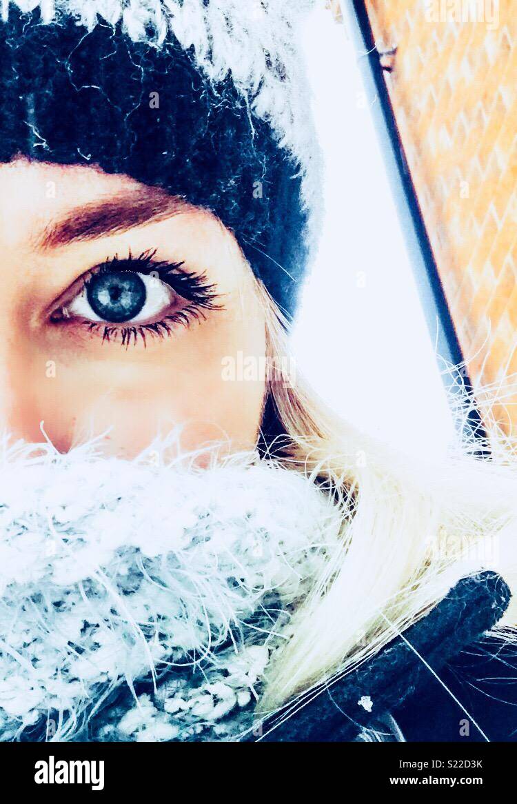 Half face portrait of a woman wrapped up for snow. Stock Photo