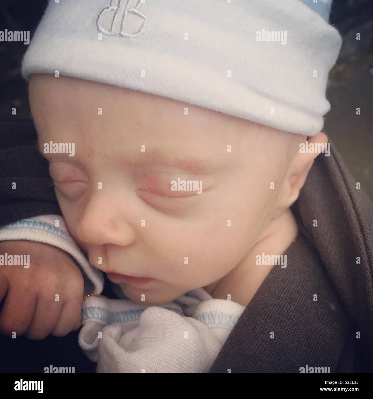 Sleeping in his sling Stock Photo Alamy