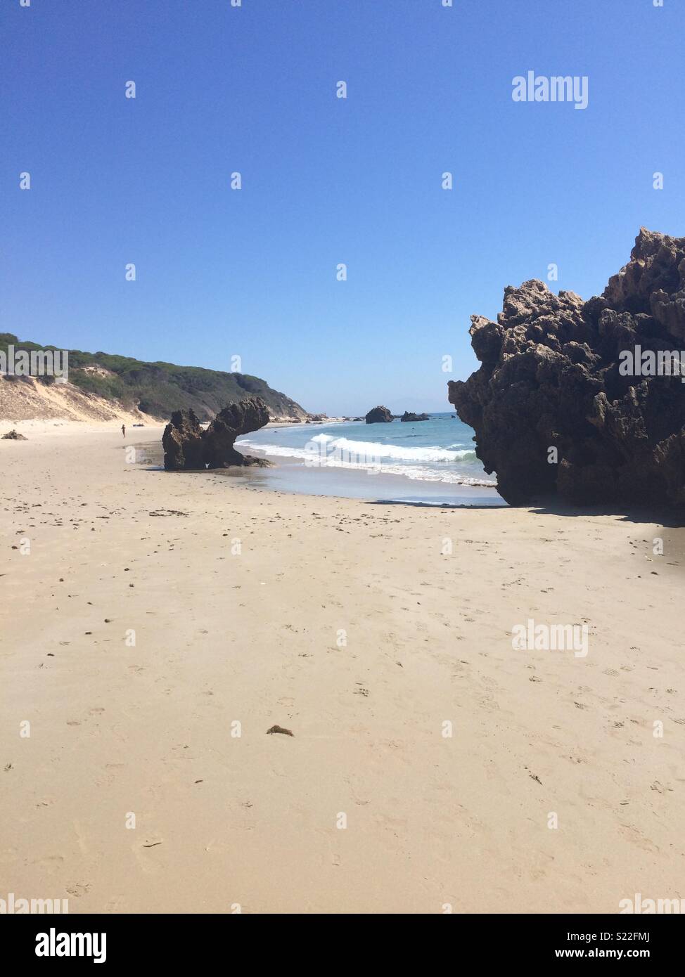 Large Rocks On Beach With Cliffs In Background High Resolution Stock ...