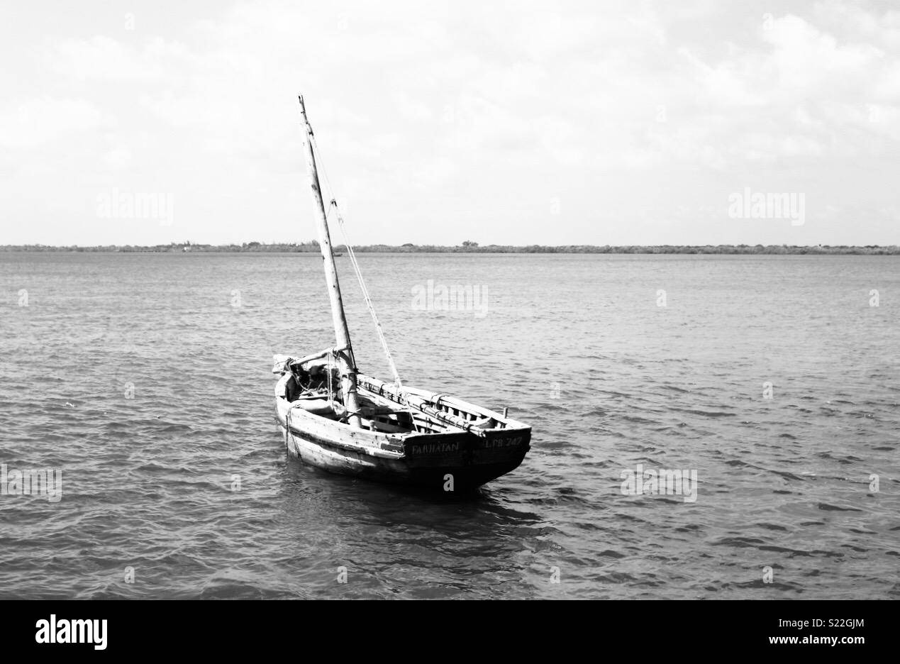 Black and white wooden boat on the sea Stock Photo - Alamy
