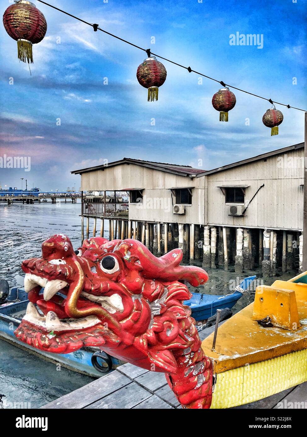 Red dragon head on the dock of a Chinese jetty in Penang, Malaysia. Stock Photo