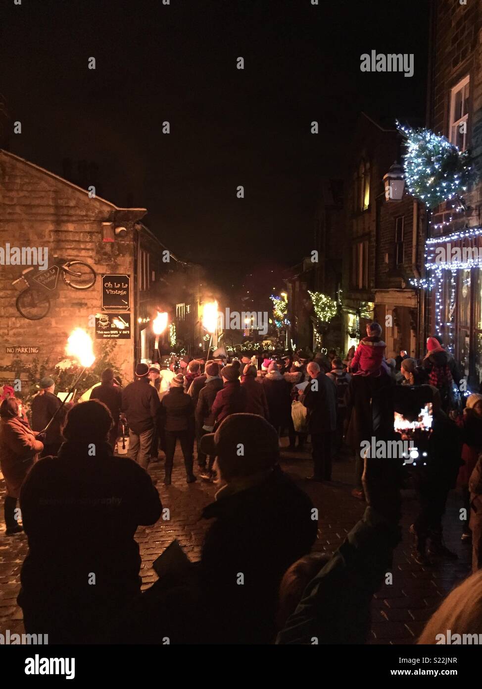 Christmas precession with torch bearing carol singers Stock Photo