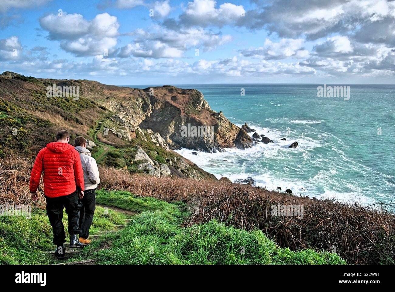 Walkers on Guernsey cliffs Stock Photo Alamy