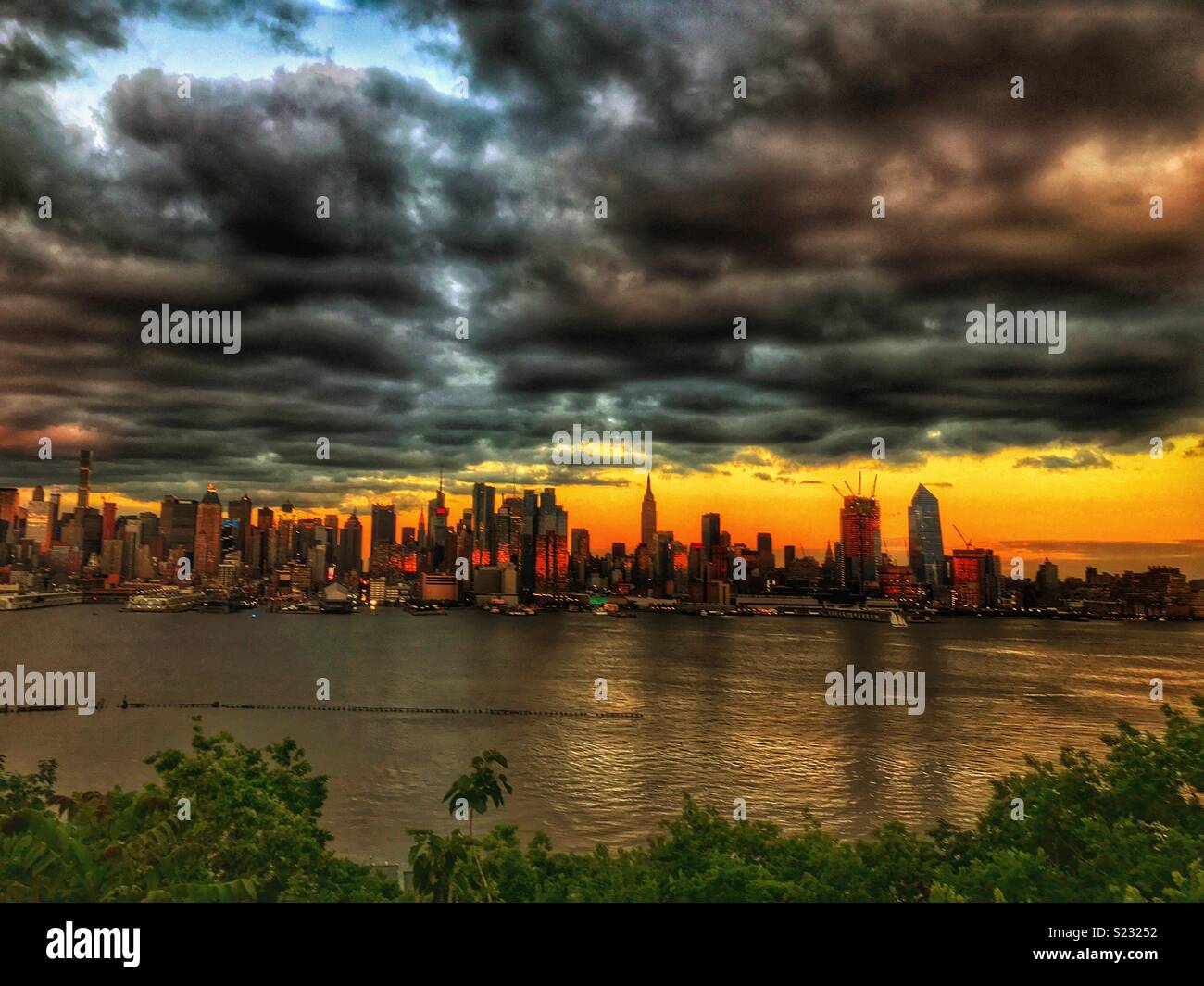 Dark clouds over sunset New York City skylines Stock Photo - Alamy