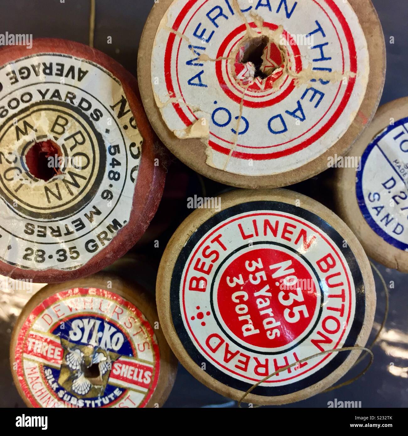 Vintage wooden cotton reels with colourful labels Stock Photo