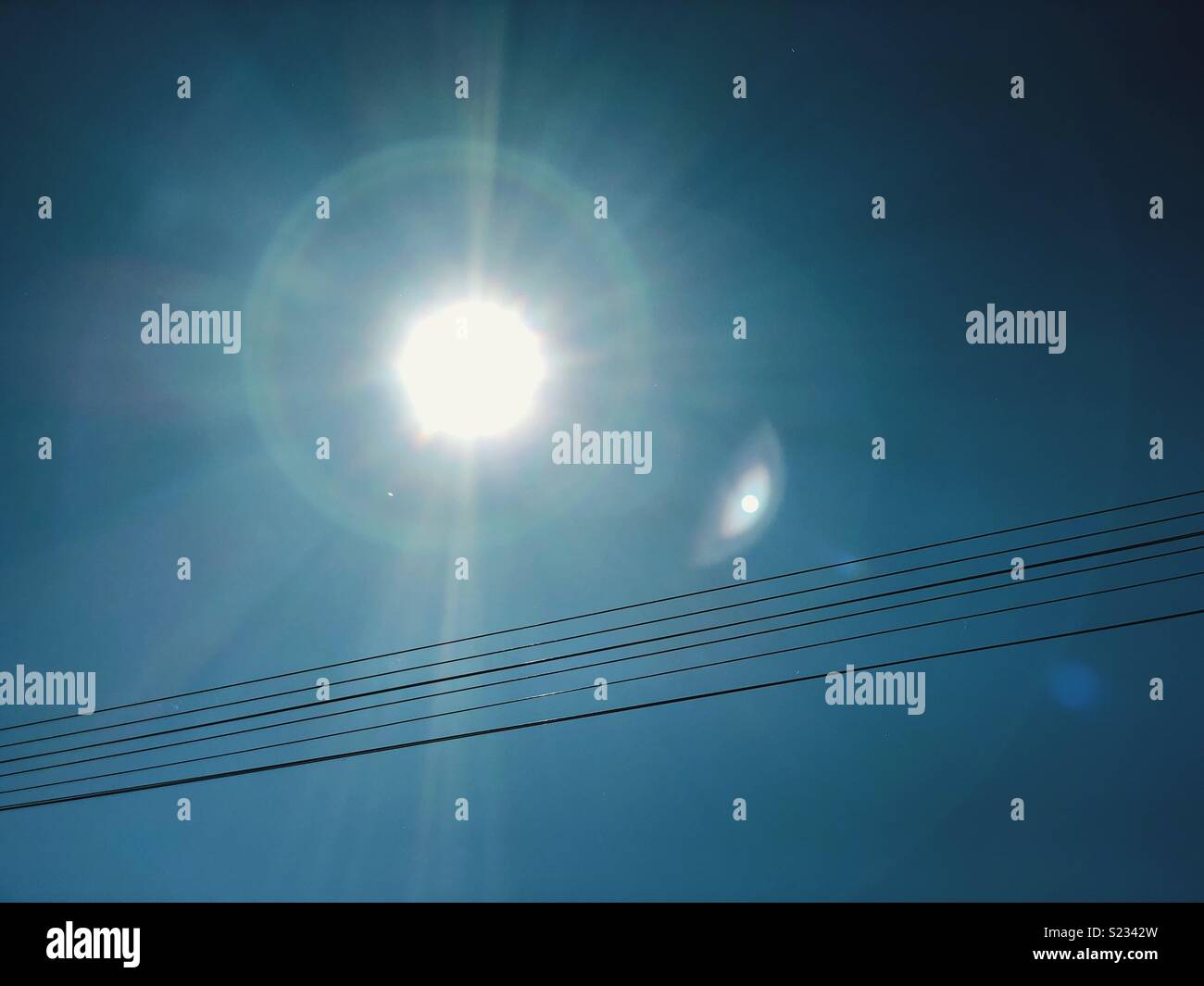 Sunlight and overhead power cables - Smartphone Captured Stock Image