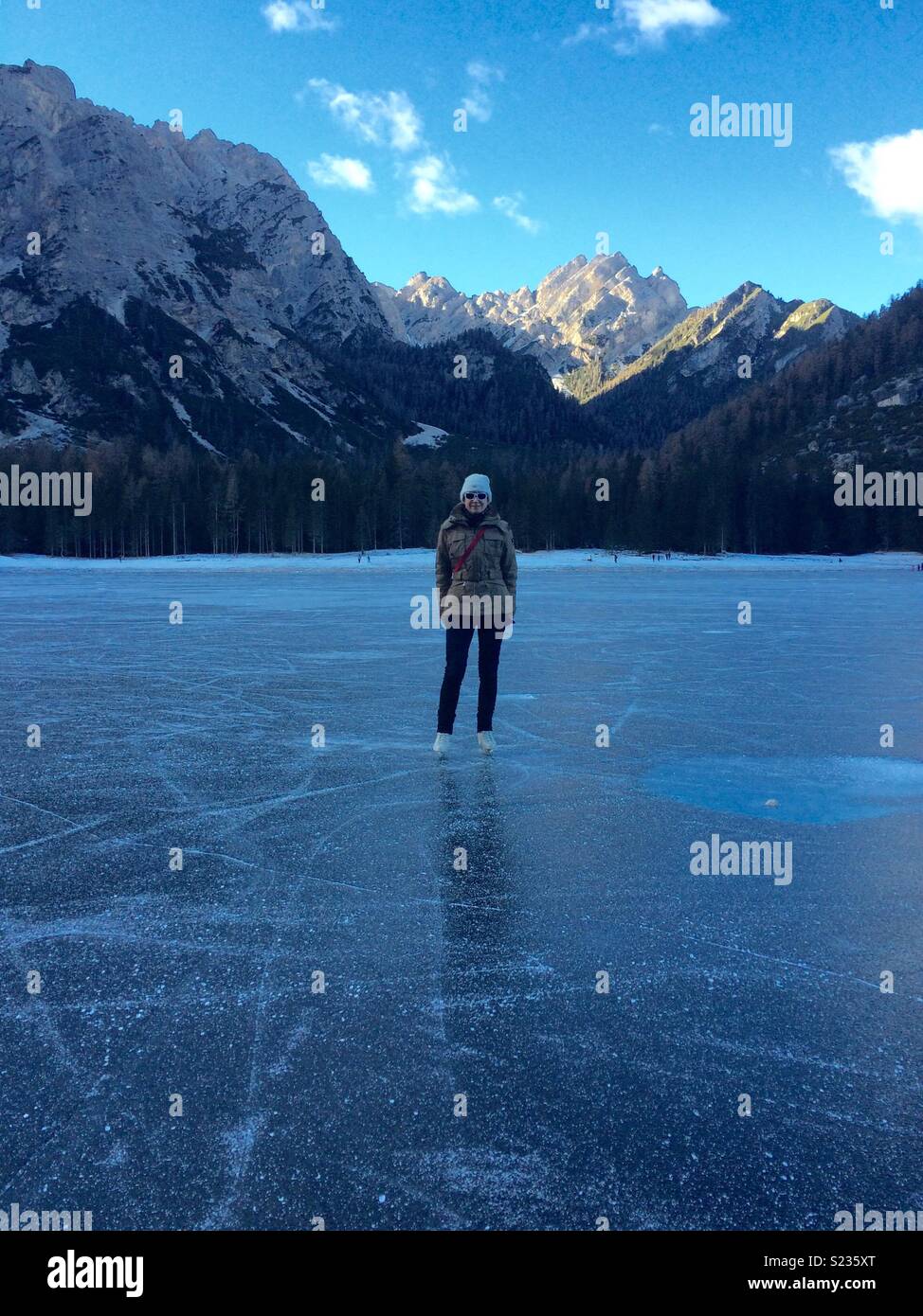 Skating on the frozen surface of Braies Lake, Italy. - Smartphone Captured Stock Image