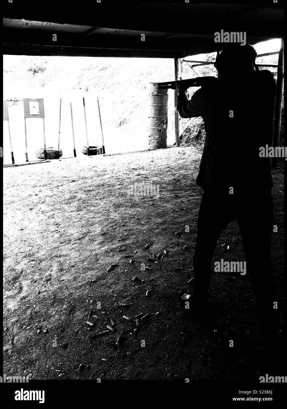 Silhouette of man shooting at shooting range. - Smartphone Captured Stock Image