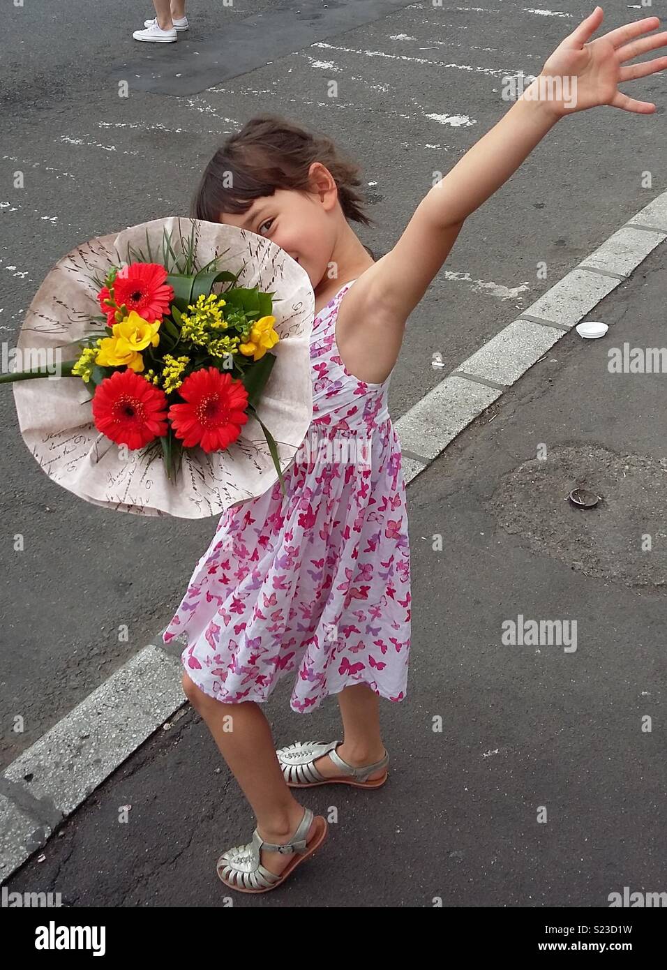 Girl in dress with bouquet of flowers Stock Photo