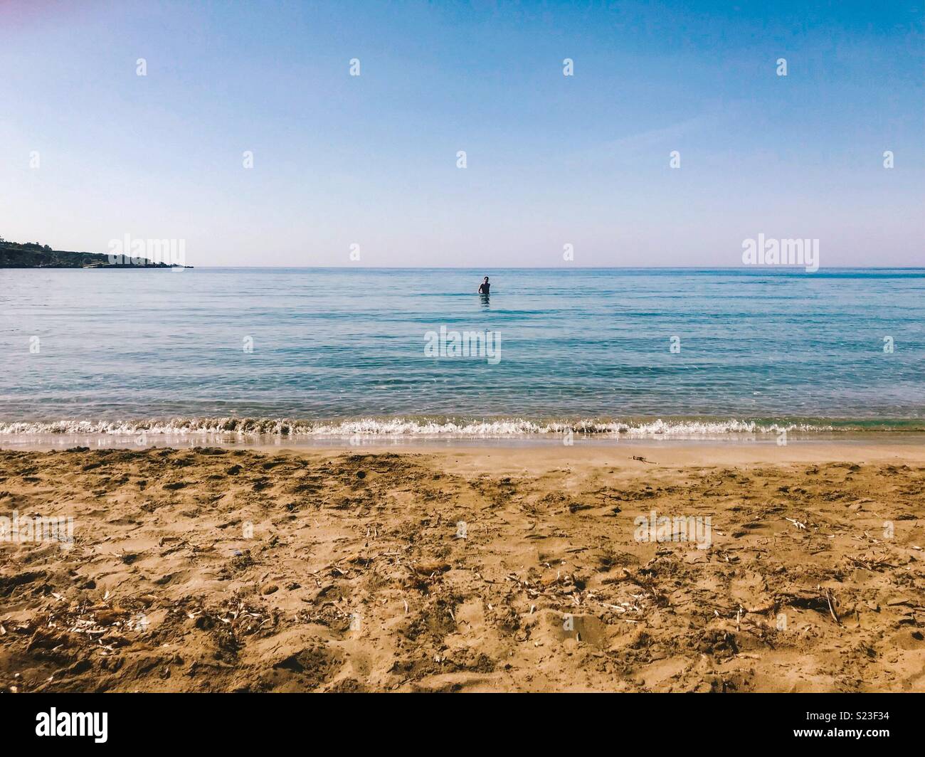Man in the sea on a beach - Smartphone Captured Stock Image