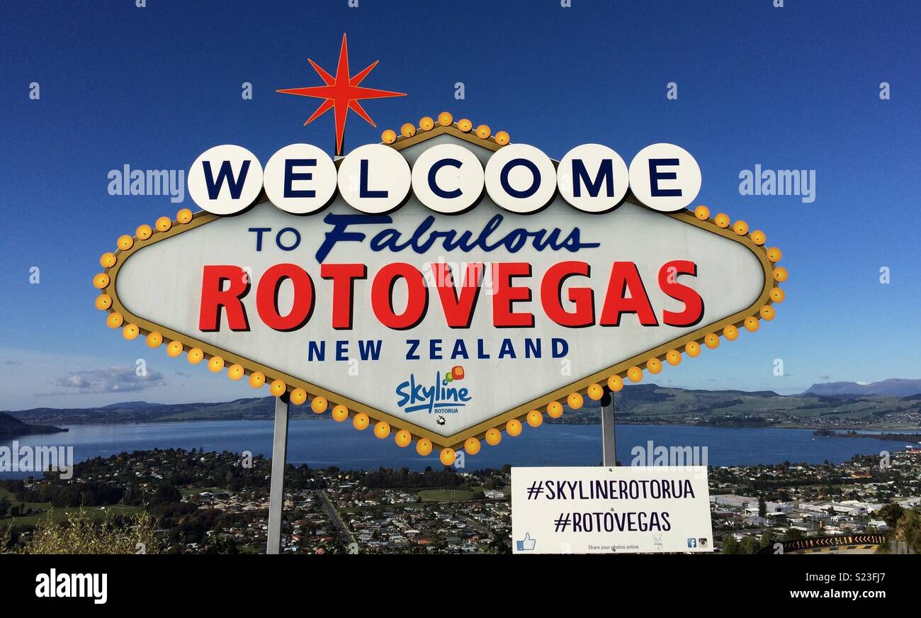 Welcome sign in Rotorua saying Welcome to Fabulous Rotovegas New Zealand, with view over the city Stock Photo