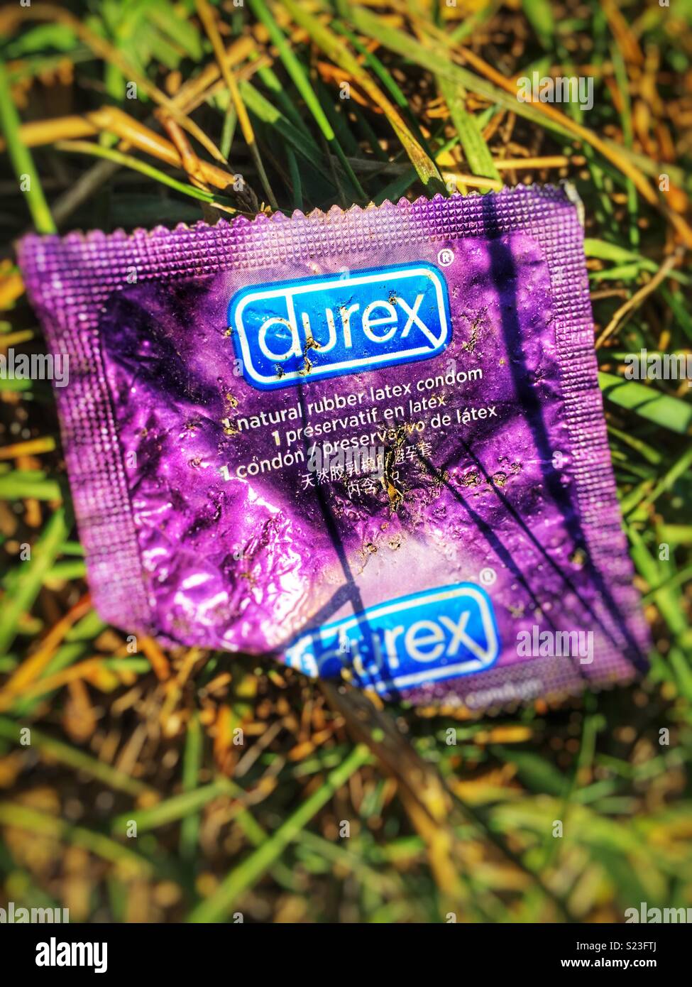 Used condom packet Stock Photo