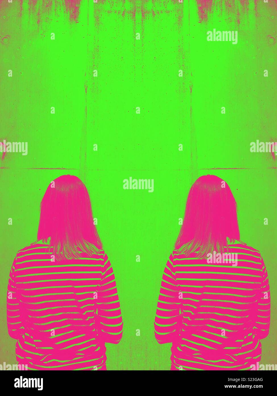 Art effect on a symmetrical image of a woman looking at a wall - Smartphone Captured Stock Image