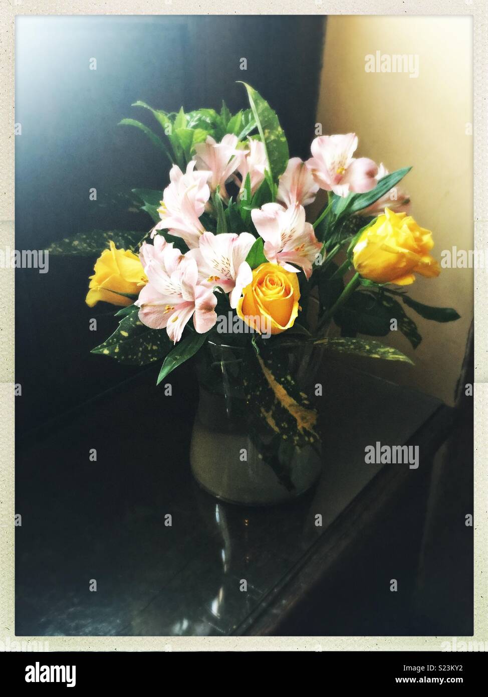 Beautiful bouquet of flowers in case with yellow roses. - Smartphone Captured Stock Image